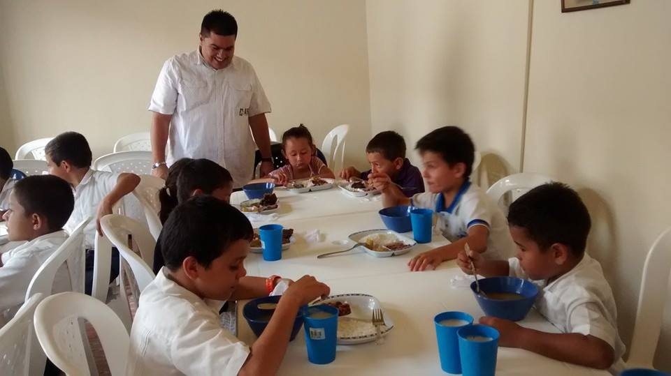 children eating and pastor Jhon